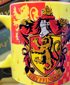 Harry Potter Gryffindor Mug displayed beside Harry Potter books and reading glasses