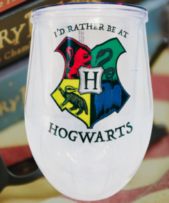 Harry Potter Hogwarts Stemless Travel Tumbler displayed with Harry Potter books, reading glasses, and a cozy blanket, creating a magical reading atmosphere.