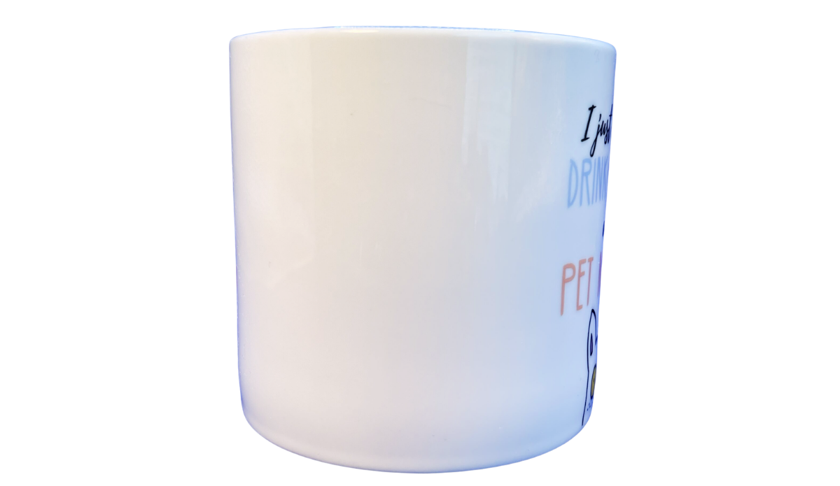Middle view of Drink Coffee And Pet My Dog Mug showing a mostly blank white ceramic side with a partial edge of the front lettering and dog illustration.