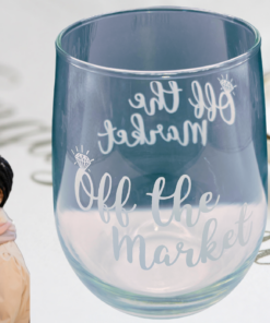 Off The Market Stemless Wine Glass displayed with engagement ring and celebration décor