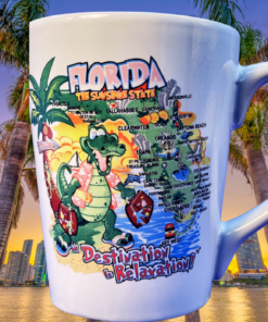 Florida Destination Is Relaxation Latte Mug displayed with palm trees and the Miami skyline at sunset