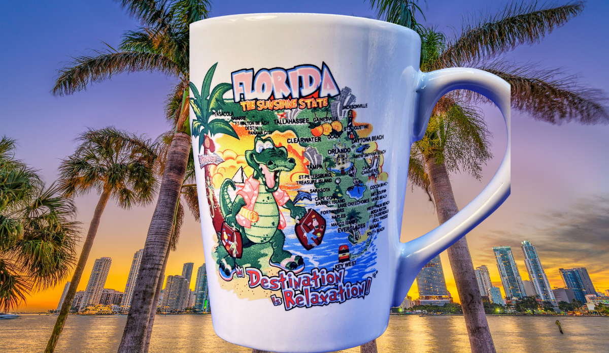 Florida Destination Is Relaxation Latte Mug displayed with palm trees and the Miami skyline at sunset