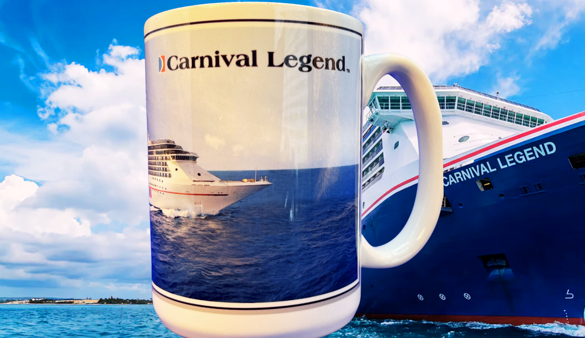 Carnival Legend Cruise Ship Souvenir Mug displayed in front of the Carnival Legend cruise ship at sea