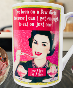 Been On A Few Diets Funny Mug in kitchen scene with ice cream sundae, cupcake, retro woman artwork, and diet joke