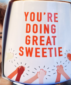 You’re Doing Great Sweetie Mug displayed beside a smiling woman giving a thumbs-up in an encouraging lifestyle scene.