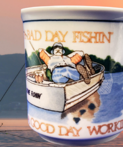 Bad Day Fishing Good Day Working Mug displayed beside fishermen enjoying a sunset fishing trip on the water