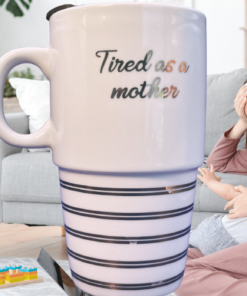tired as a mother ceramic travel mug on kitchen counter with stripe base detail visible