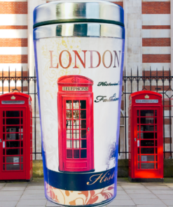 London England travel tumbler surrounded by traditional red British telephone boxes in a London street scene