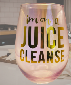 iridescent juice cleanse wine glass styled with wine and cozy setting