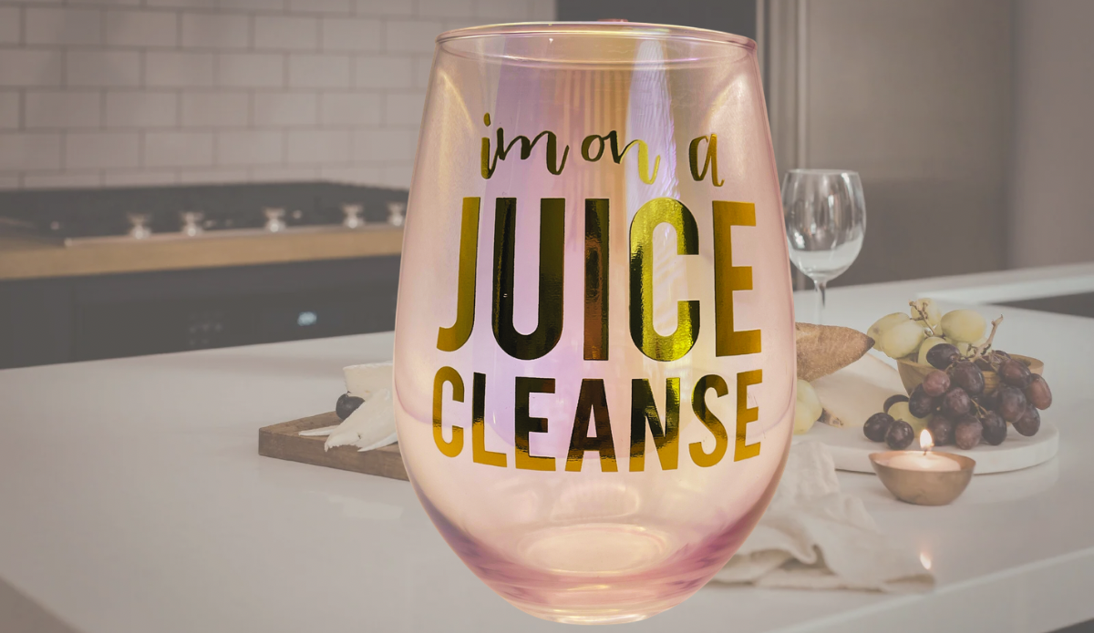 iridescent juice cleanse wine glass styled with wine and cozy setting