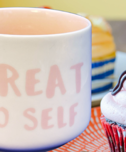 Treat Yo Self mug with cupcake and dessert setting cozy self care moment