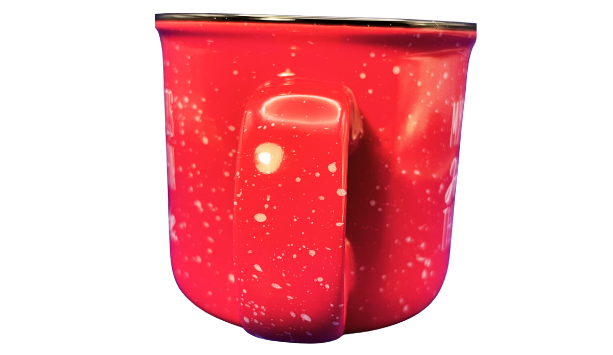 Handle view of red husband hotter coffee mug with cream speckles, dark rim, and wide sculpted ceramic handle