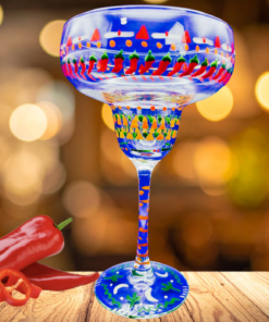 Southwestern chili peppers margarita glass on wooden table with warm lighting and fresh chili peppers