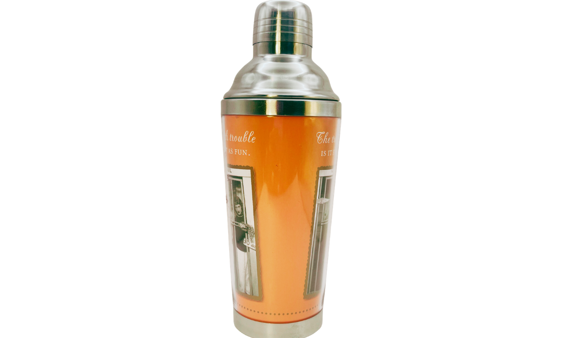 Trouble Starts Cocktail Shaker side view with bright orange wrap, partial jail photographs, and polished metal top