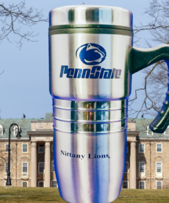 Penn State Travel Mug displayed on Penn State campus with university building and flag in the background