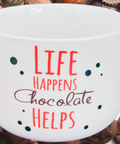 Life Happens Chocolate Helps Mug with chocolates cozy kitchen setting
