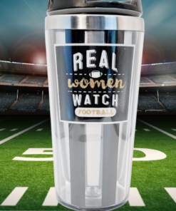 Real Women Watch Football Tumbler displayed on a football field inside a brightly lit stadium