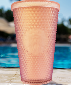 Starbucks Iridescent Rainbow Studded Venti Tumbler displayed beside a swimming pool