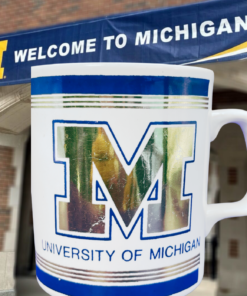 University of Michigan Mug displayed against a Michigan-themed entrance with a Welcome to Michigan banner