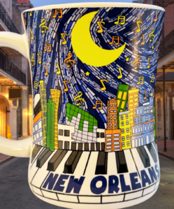 New Orleans Piano Music Skyline Mug displayed in a glowing New Orleans street setting