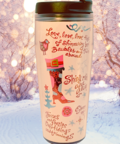 Tinsel Sparkles Black Lid Tumbler displayed in a snowy winter setting with glowing holiday lights