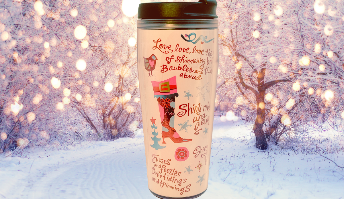 Tinsel Sparkles Black Lid Tumbler displayed in a snowy winter setting with glowing holiday lights