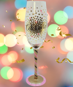 Celebrate Champagne Flute With Gold Confetti displayed against colorful party lights with golden streamers, floating confetti, and festive decorations.