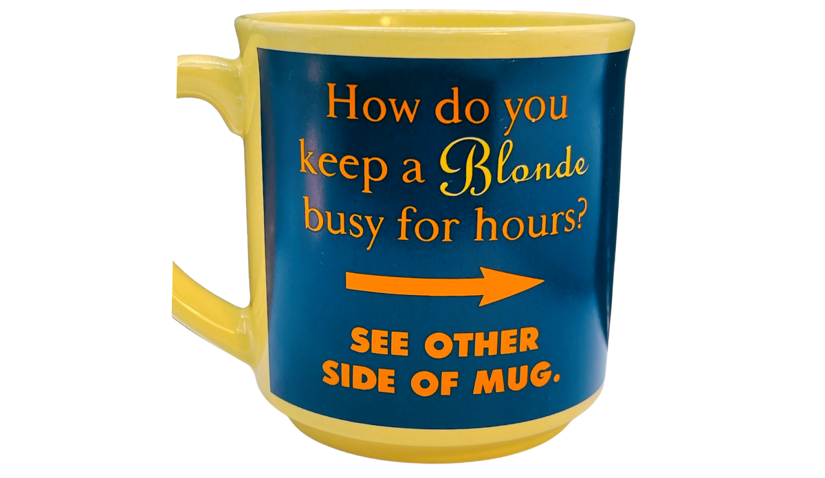 How Do You Keep A Blonde Busy Mug front view with yellow exterior, deep blue panel, orange arrow, and two-sided joke wording