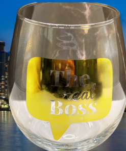The Real Boss Stemless Wine Glass displayed against illuminated nighttime city skyline