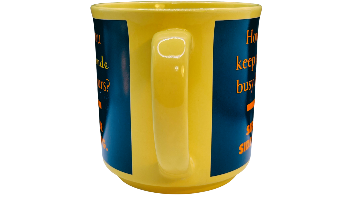How Do You Keep A Blonde Busy Mug handle view showing the bright yellow handle between deep blue joke panels