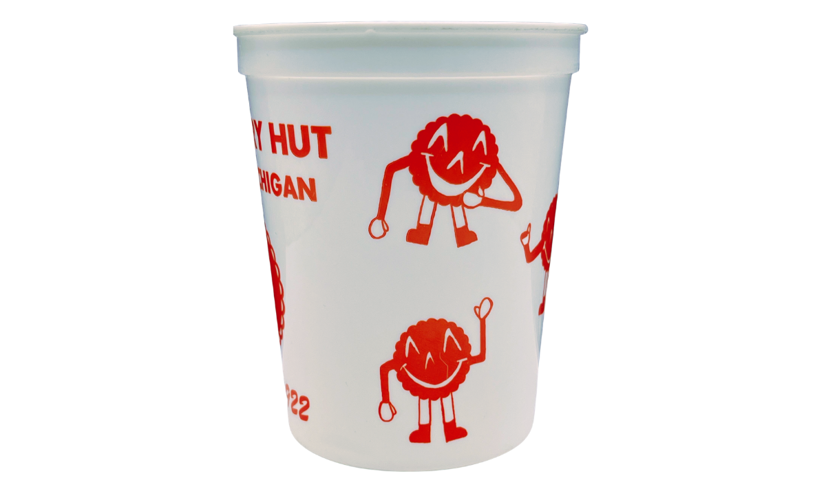 Vintage Cherry Hut souvenir cup with red smiling cherry characters on frosted white surface