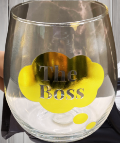 The Boss Stemless Wine Glass displayed in an office-inspired scene with a woman reclining in a chair