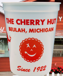 Vintage Cherry Hut Beulah Michigan souvenir cup displayed in front of The Cherry Hut