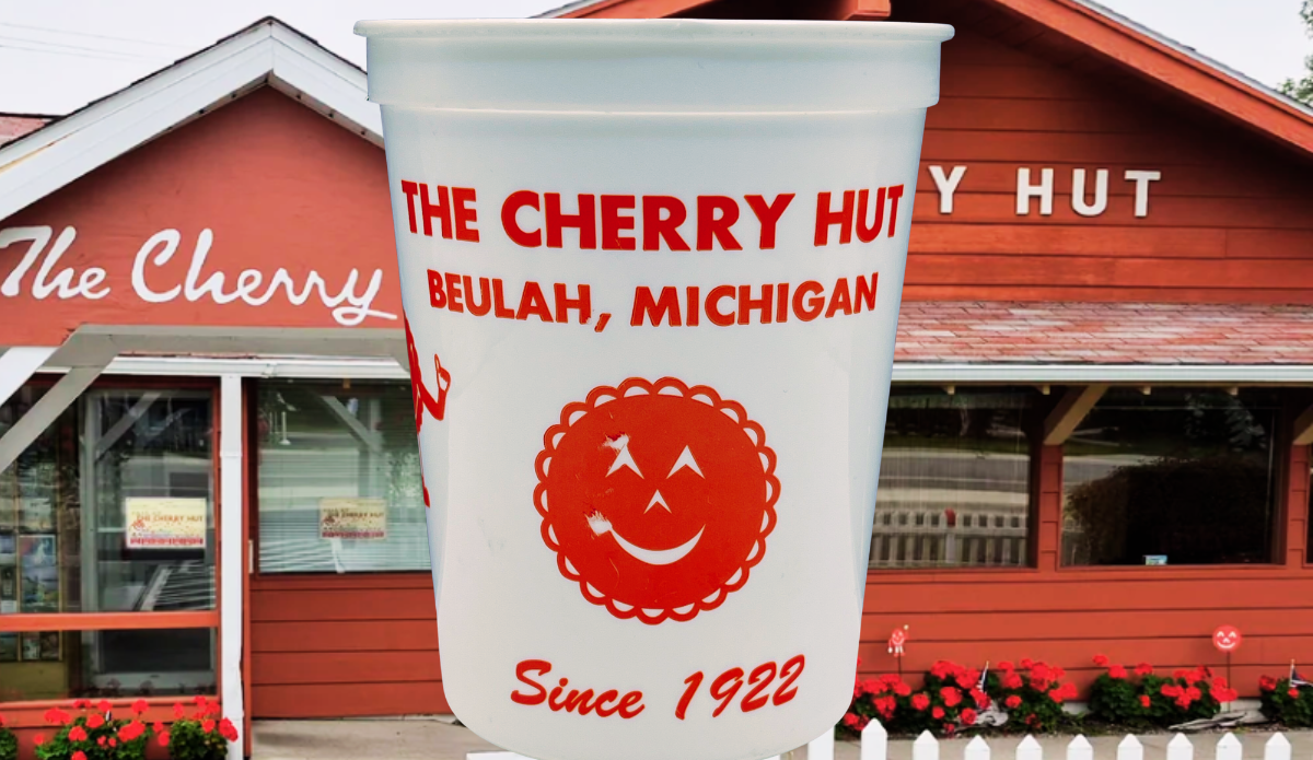 Vintage Cherry Hut Beulah Michigan souvenir cup displayed in front of The Cherry Hut