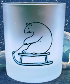 Sledding polar bear frosted whiskey glass styled beside icy winter landscape