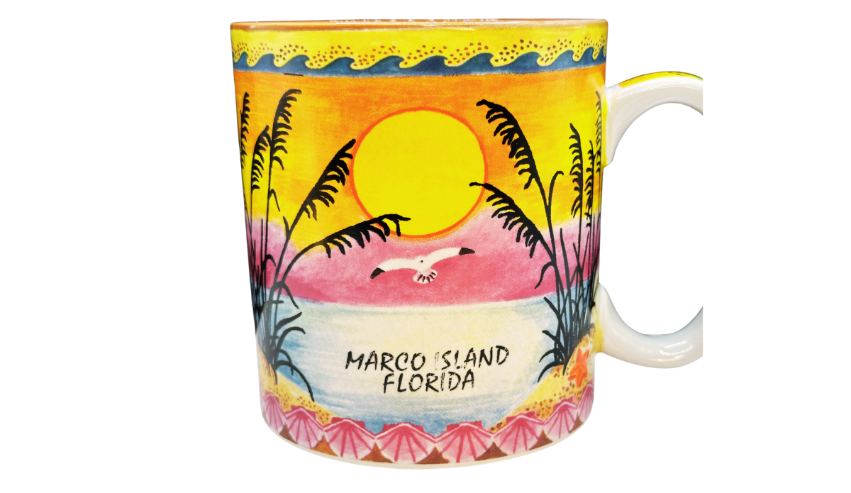 Marco Island Florida souvenir mug featuring a colorful sunset over the Gulf, soaring seabird, sea oats, and wraparound tropical beach artwork.