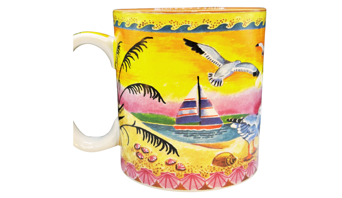 Back view of Marco Island Florida souvenir mug featuring colorful sailboat, flying seagulls, seashells, sandy beach, and wraparound tropical coastal scene.