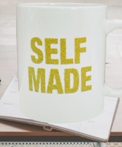 Self Made gold glitter mug on desk workspace with laptop and planner
