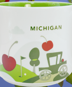 Starbucks Michigan Mug displayed among red cherries and green leaves against a blue sky