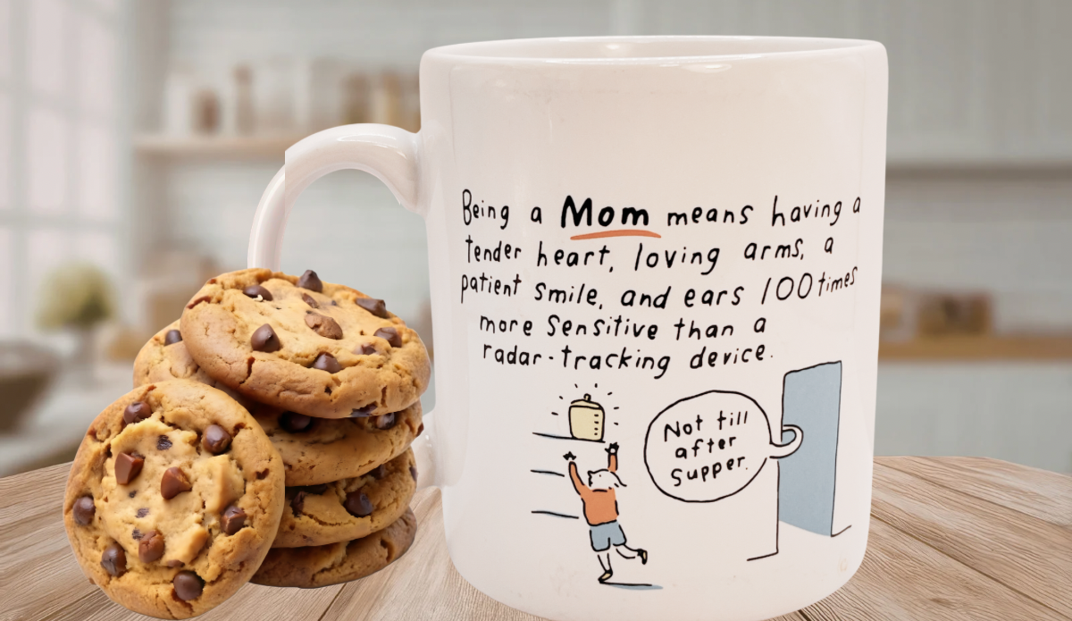 Hallmark Being A Mom Means Funny Mug with chocolate chip cookies on a kitchen table