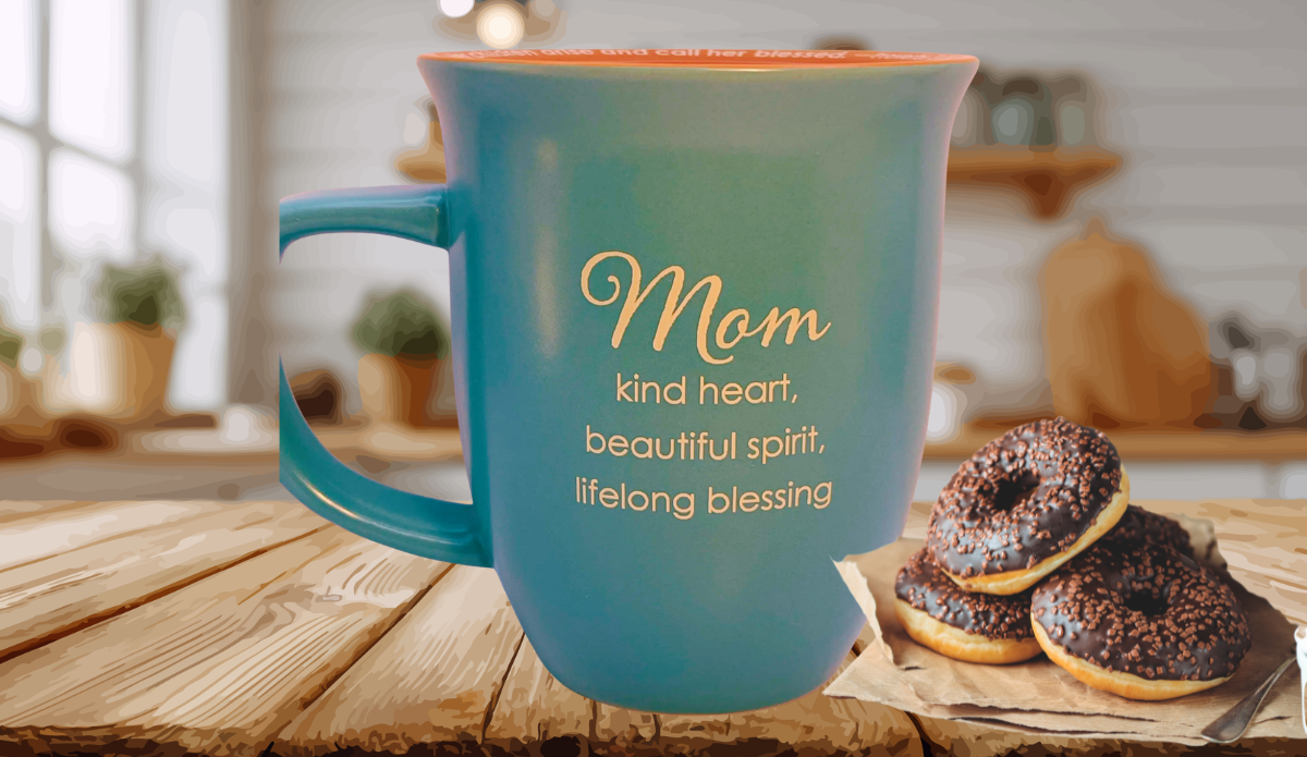 Abbey Gift Mom blessing teal mug on wooden table with chocolate donuts in cozy kitchen setting