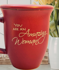Abbey Gift amazing woman mug styled on kitchen counter with flowers