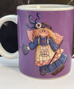 Add heavenly grace and garden magic to your mornings with the Purple Mindy Cain Garden Angel Mug. It's the perfect #cupofmood and serenity in every sip.
