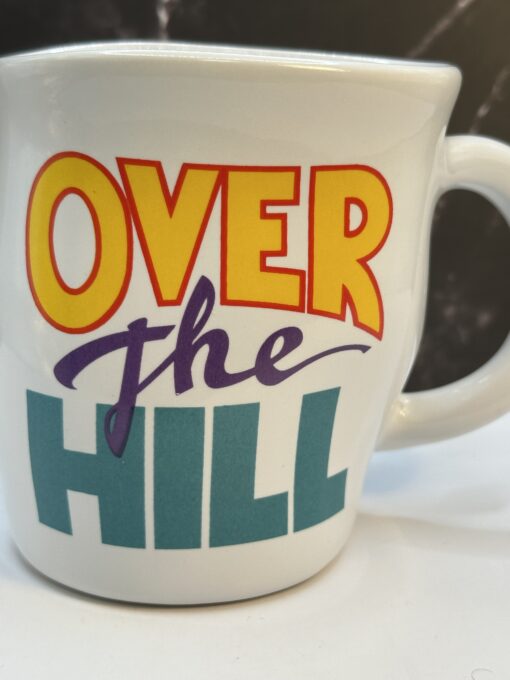 Say hello to witty sips—with the Papel Over the Hill Retirement Coffee Mug. It's the perfect #cupofmood to wave goodbye to work.