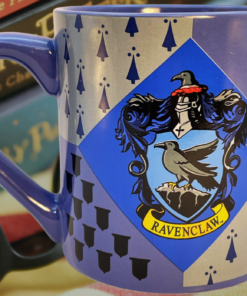 Harry Potter Ravenclaw House Crest Mug displayed with Harry Potter books and reading glasses in a cozy Wizarding World setting