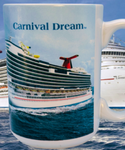 Carnival Dream Cruise Ship Souvenir Mug displayed in front of Carnival Dream cruise ship at sea