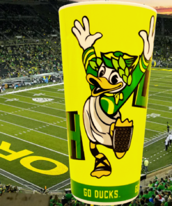 Oregon Ducks Puddles Stadium Cup displayed against an Oregon football stadium filled with green and yellow fans
