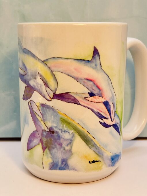 Close-up of pastel dolphin illustrations on 10oz ceramic mug