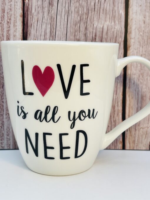 Sip your favorite drink in style with the 14oz Love Is All You Need Mug by Pflatzgraff. Dishwasher safe, microwave safe, and perfect as a gift or personal treat!