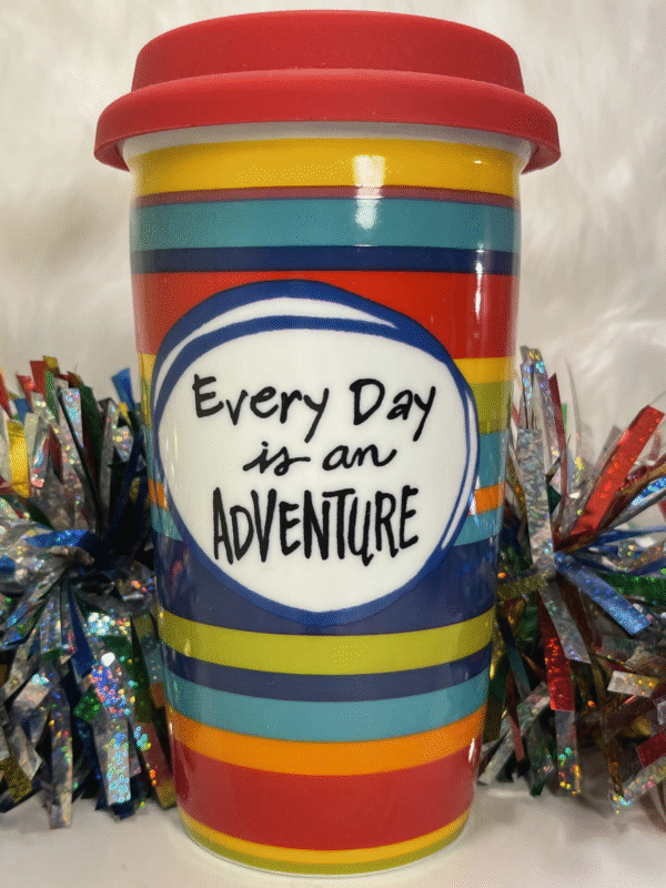 This Pier 1 Adventure Travel Tumbler is a unique porcelain coffee cup with a lid. The Mug by Pier 1 says Every Day Is An Adventure holds on the front.